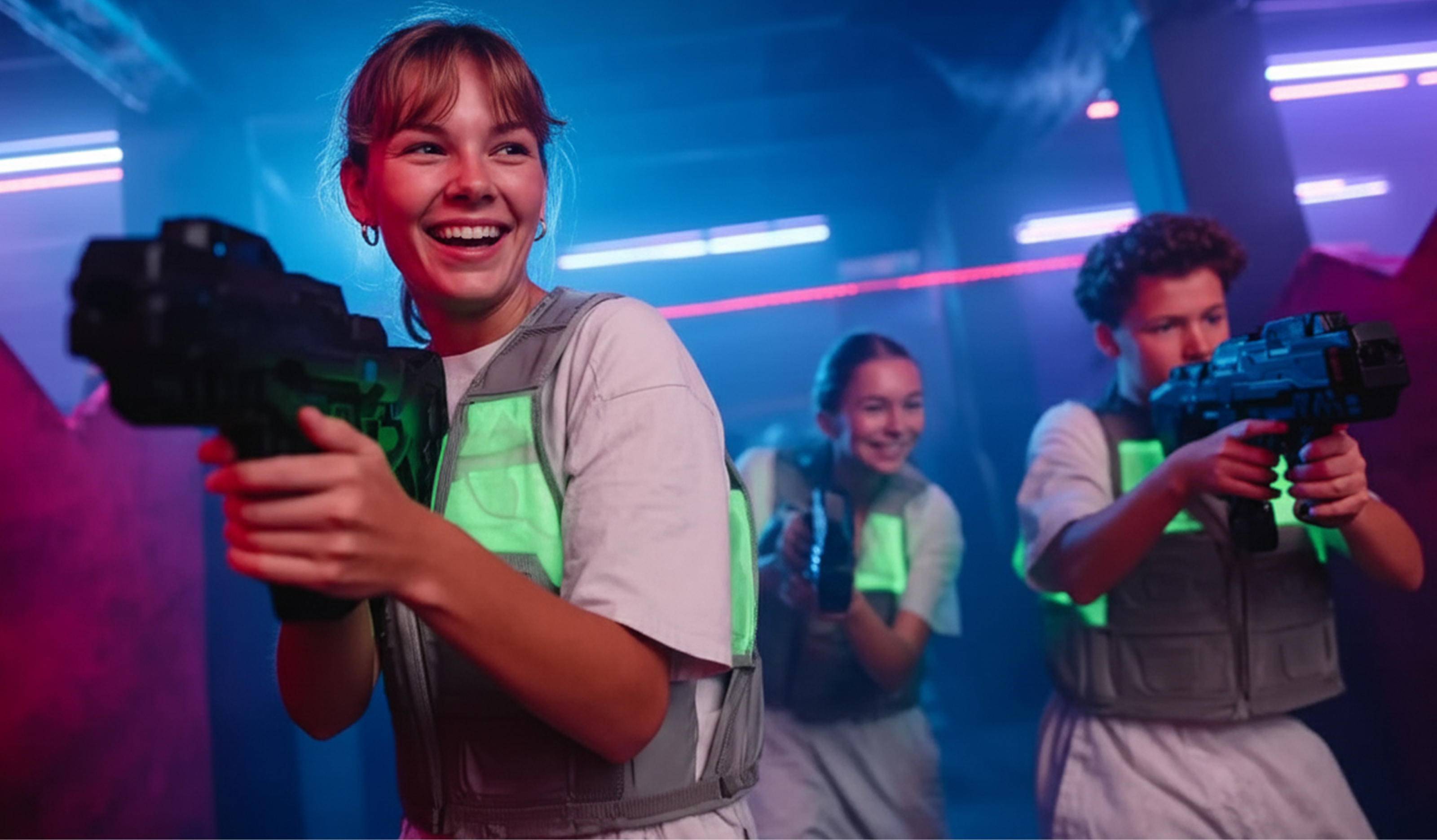 A group of young people playing laser tag and laughing